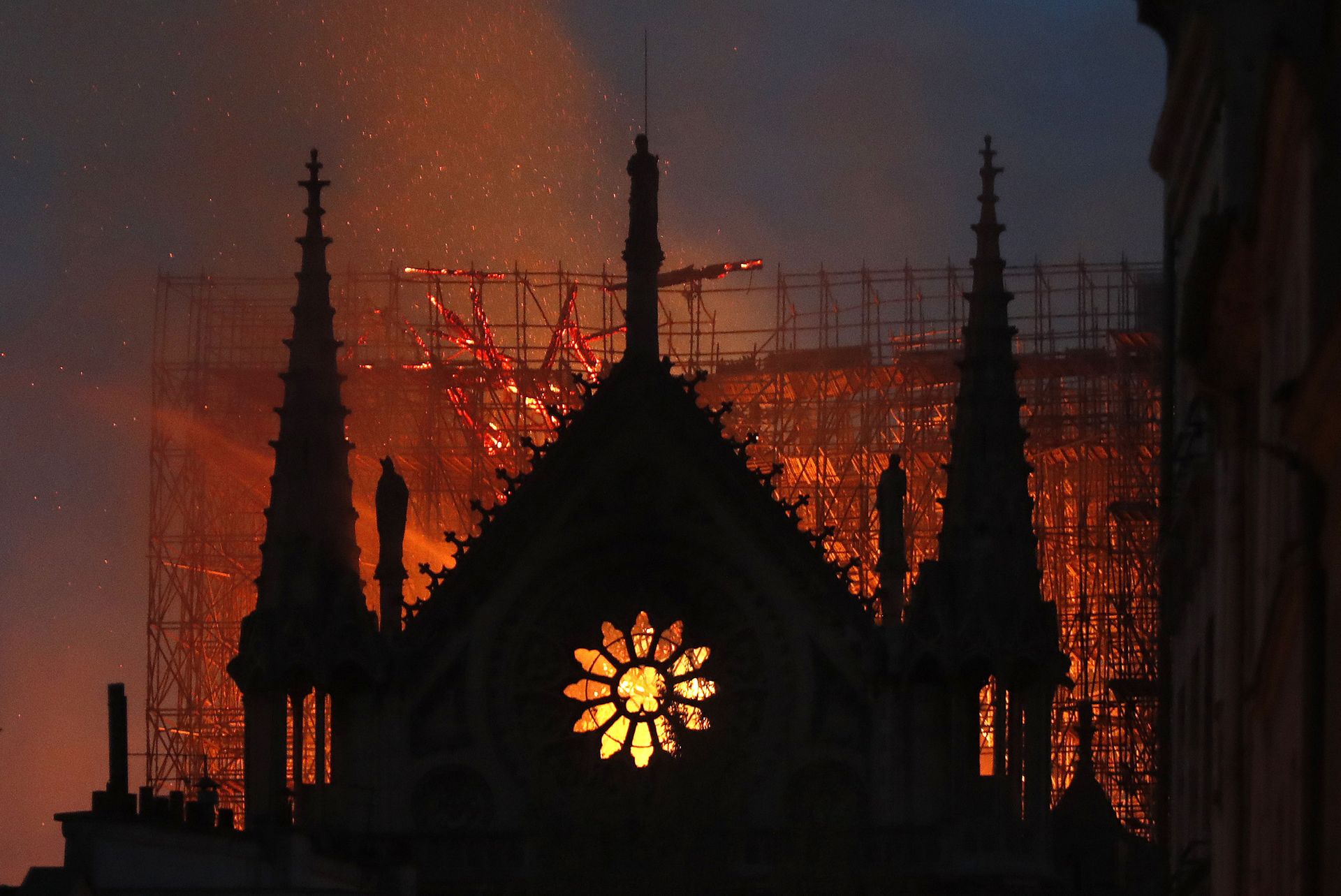 In this April 15, 2019, file photo, flames and smoke rise from Notre Dame Cathedral as it burns in Paris. The cathedral stands crippled, locked in a dangerous web of twisted metal scaffolding one year after a cataclysmic fire gutted its interior, toppled its famous spire and horrified the world. (AP Photo/Thibault Camus, File) In this April 15, 2019, file photo, flames and smoke rise from Notre Dame Cathedral as it burns in Paris. The cathedral stands crippled, locked in a dangerous web of twisted metal scaffolding one year after a cataclysmic fire gutted its interior, toppled its famous spire and horrified the world. (AP Photo/Thibault Camus, File) - Sputnik International, 1920, 12.01.2025
