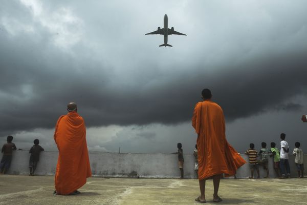 Buddhists monks and children look out from the rooftop at a Buddhist mission hostel and school for underprivileged children as an international passenger flight takes off at the Netaji Subhash Chandra Bose International Airport after the authorities eased restrictions imposed as a preventive measure against the spread of COVID-19, in Kolkata on 5 July 2020. Buddhists monks and children look out from the rooftop at a Buddhist mission hostel and school for underprivileged children as an international passenger flight takes off at the Netaji Subhash Chandra Bose International Airport after the authorities eased restrictions imposed as a preventive measure against the spread of COVID-19, in Kolkata on 5 July 2020. - Sputnik International