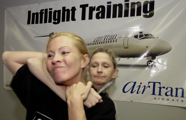 AirTran Airways flight attendant Clarissa Zimmermann, left, fends off an attacker played by fellow flight attendant Helen Ward, during a personal defence course given to AirTran flight attendants by instructors from Intelligence Strategies, Wednesday, Feb. 13, 2002, at the airline's training facility in College Park, Ga AirTran Airways flight attendant Clarissa Zimmermann, left, fends off an attacker played by fellow flight attendant Helen Ward, during a personal defence course given to AirTran flight attendants by instructors from Intelligence Strategies, Wednesday, Feb. 13, 2002, at the airline's training facility in College Park, Ga - Sputnik International