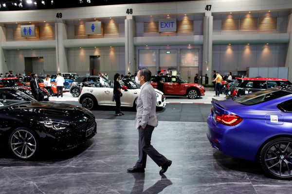 A man wearing a face mask walks between two BMW vehicles during the media day of the 41st Bangkok International Motor Show after the Thai government eased measures to prevent the spread of the coronavirus disease (COVID-19) in Bangkok, Thailand July 14, 2020. A man wearing a face mask walks between two BMW vehicles during the media day of the 41st Bangkok International Motor Show after the Thai government eased measures to prevent the spread of the coronavirus disease (COVID-19) in Bangkok, Thailand July 14, 2020. - Sputnik International