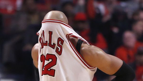 Chicago Bulls forward Taj Gibson puts his jersey over his face after being called for a foul during the second half of an NBA basketball game against the Sacramento Kings Tuesday, Feb. 10, 2015, in Chicago. The Bulls won 104-86 - Sputnik International