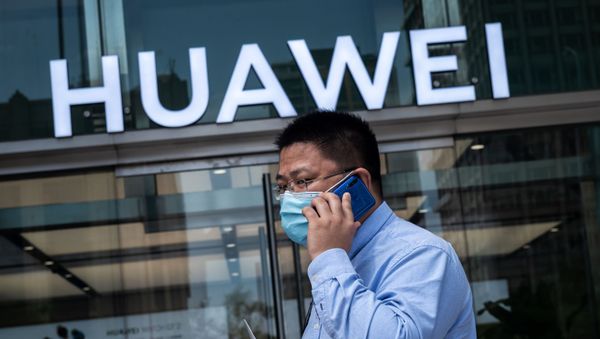 In this file photo taken on May 25, 2020 a man walks past a shop for Chinese telecoms giant Huawei in Beijing, China. In this file photo taken on May 25, 2020 a man walks past a shop for Chinese telecoms giant Huawei in Beijing, China. - Sputnik International