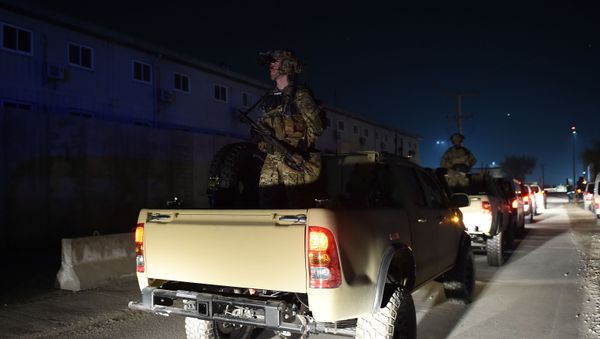 US Soldiers stand guard as US President Donald Trump makes a surprise Thanksgiving day visit to the US troops at Bagram Air Field, on November 28, 2019 in Afghanistan. - Sputnik International