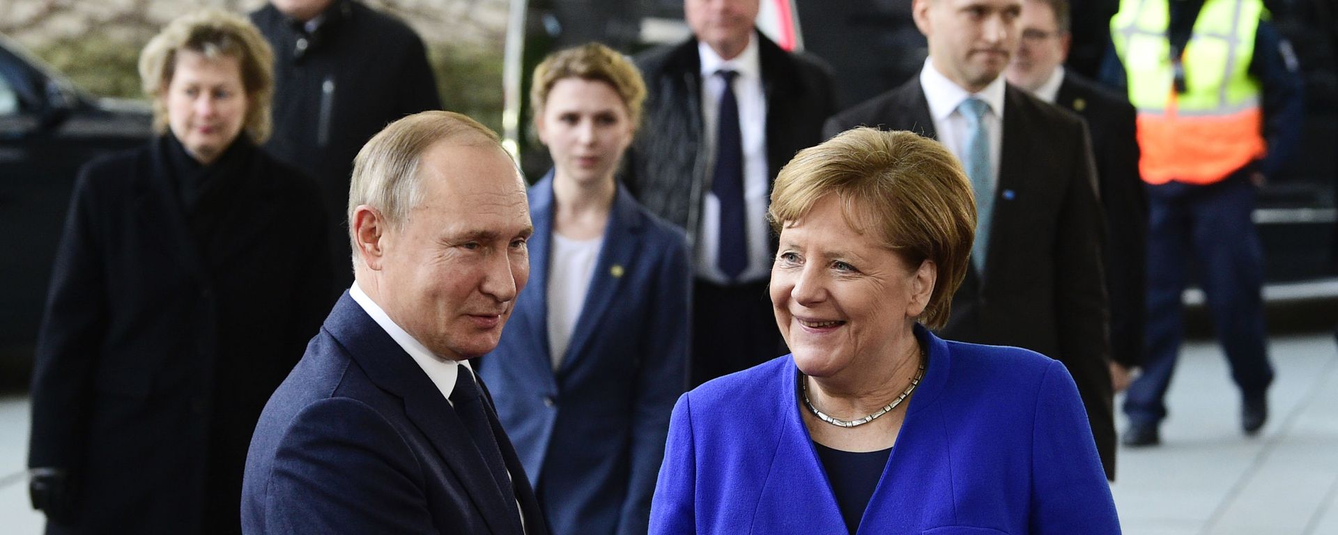 German Chancellor Angela Merkel, right, shakes hands with Russian President Vladimir Putin during arrivals for a conference on Libya at the chancellery in Berlin, Germany, Sunday, Jan. 19, 2020 German Chancellor Angela Merkel, right, shakes hands with Russian President Vladimir Putin during arrivals for a conference on Libya at the chancellery in Berlin, Germany, Sunday, Jan. 19, 2020 - Sputnik International, 1920, 24.06.2021