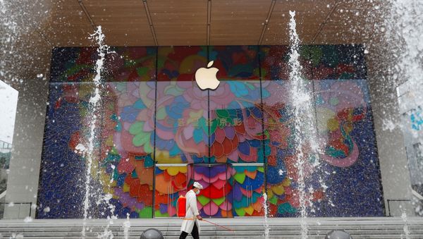 A worker sprays disinfectant outside the new Apple flagship store in Sanlitun after an outbreak of the coronavirus disease (COVID-19) in Beijing, China July 13, 2020 - Sputnik International