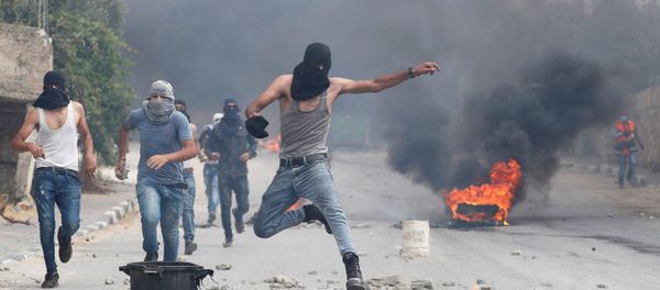 A demonstrator jumps during an anti-Israel protest following the funeral of Palestinian man Ibraheem Yakoub, in Kifl Haris in the Israeli-occupied West Bank, 10 July 2020 - Sputnik International