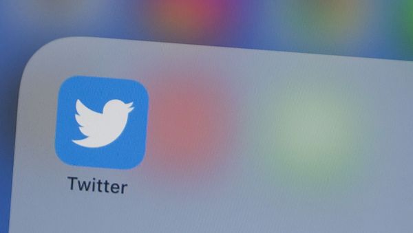 (FILES) In this file photo taken on July 10, 2019, the Twitter logo is seen on a phone in this photo illustration in Washington, DC. - The official Twitter accounts of Apple, Elon Musk, Jeff Bezos and others were hijacked on Wednesday by scammers trying to dupe people into sending cryptocurrency bitcoin in the hope of doubling their money - Sputnik International