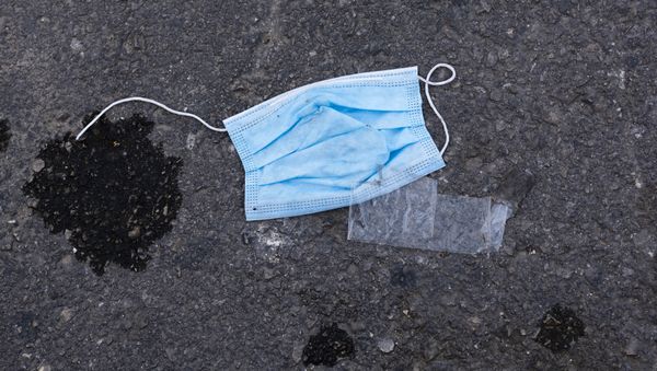 In this Saturday, April 4, 2020 photo, a protective face mask is thrown on the ground outside a supermarket during a lockdown following government measures to help stop the spread of the coronavirus in Tel Aviv, Israel - Sputnik International