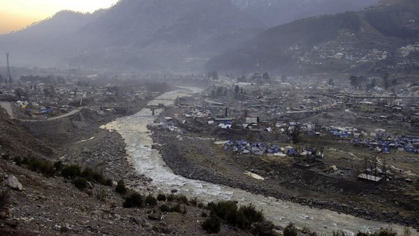 The sun sets on the partially ruined Pakistani Kashmiri city of Balakot, 09 January 2006, two days ahead of the Muslim festival of Eid al-Adha -- the feast of sacrifice, Islam's second biggest annual festival - Sputnik International