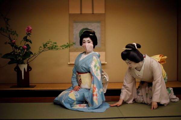 Mayu adjusts Koiku's kimono, as Koiku wears a protective face mask to pose for a photograph, before working at a party where they will entertain customers along with other geisha, at Asada, a luxury Japanese restaurant, during the coronavirus (COVID-19) outbreak, in Tokyo, Japan, June 23, 2020 - Sputnik International