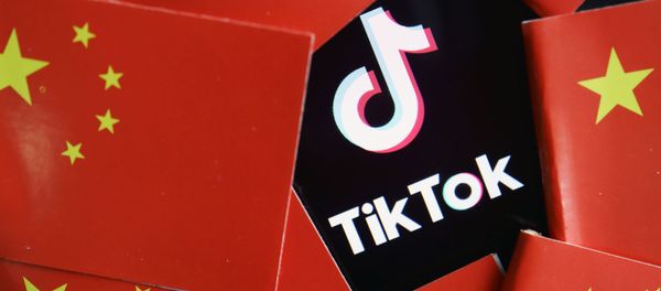 China's flags are seen near a TikTok logo in this illustration picture taken July 16, 2020 China's flags are seen near a TikTok logo in this illustration picture taken July 16, 2020 - Sputnik International