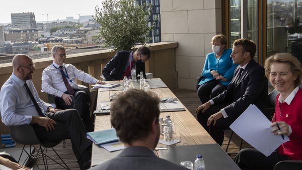 European Council President Charles Michel (L), German Chancellor Angela Merkel (3rd R), French President Emmanuel Macron (2nd R), and European Commission President Ursula von der Leyen (R) meet on the sidelines of an EU summit on a coronavirus recovery package at the European Council building in Brussels on July 18, 2020 - Sputnik International