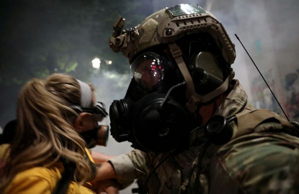 A federal law enforcement officer pushes a mother back during a demonstration against the presence of federal law enforcement officers and racial inequality in Portland, Oregon, US, 21 July 2020 A federal law enforcement officer pushes a mother back during a demonstration against the presence of federal law enforcement officers and racial inequality in Portland, Oregon, US, 21 July 2020 - Sputnik International