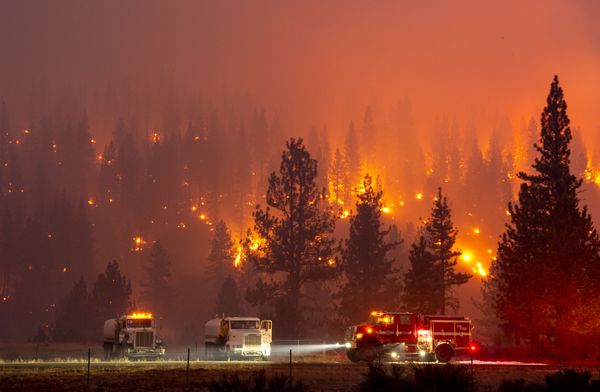 In this long exposure photograph, firefighters m
op up hot spots from the Hog fire along Highway 36 about 5 miles from Susanville, California on 20 July 2020 In this long exposure photograph, firefighters m
op up hot spots from the Hog fire along Highway 36 about 5 miles from Susanville, California on 20 July 2020 - Sputnik International
