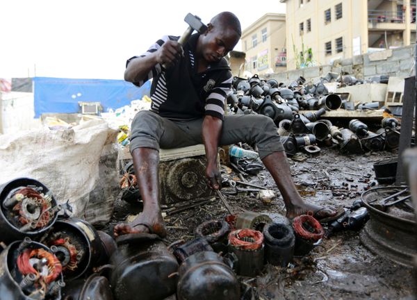 A man works on discarded compressors at a recycling centre in Abuja, Nigeria June 18, 2020 A man works on discarded compressors at a recycling centre in Abuja, Nigeria June 18, 2020 - Sputnik International