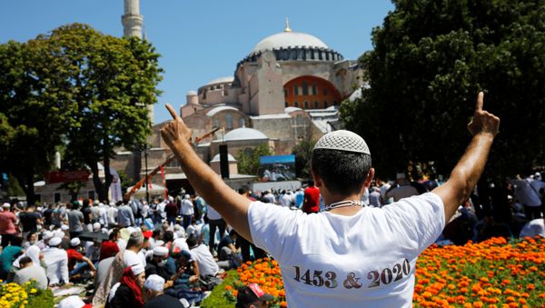 A man gestures as people wait for the beginning of Friday prayers outside Hagia Sophia Grand Mosque, for the first time after it was once again declared a mosque after 86 years, in Istanbul, Turkey, July 24, 2020 - Sputnik International