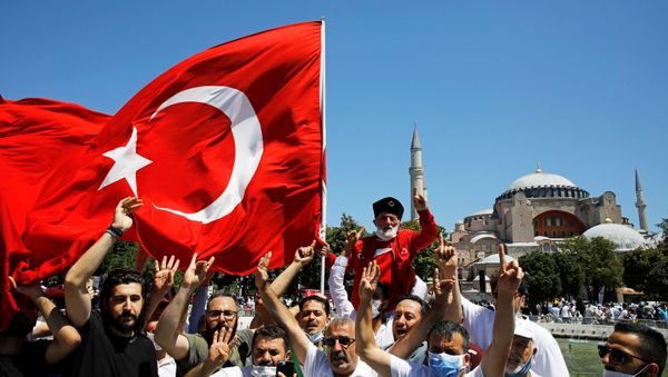 People gesture as they wait for the beginning of Friday prayers outside Hagia Sophia Grand Mosque, for the first time after it was once again declared a mosque after 86 years, in Istanbul, Turkey, July 24, 2020 - Sputnik International