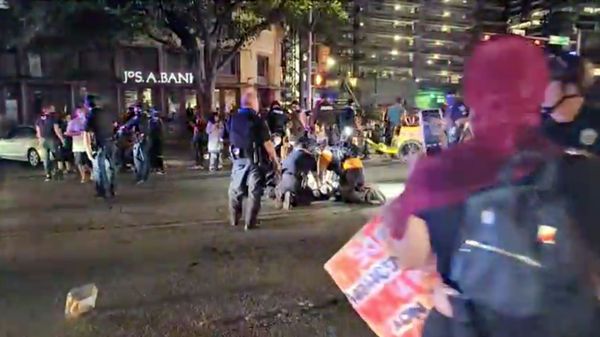Police and protesters gather around a demonstrator who got shot after several shots were fired during a Black Lives Matter protest in downtown Austin, Texas, U.S., July 25, 2020 in this screen grab obtained from a social media video. - Sputnik International