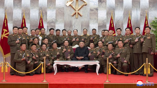 North Korean leader Kim Jong Un poses for a photograph after conferring Paektusan commemorative pistols to leading commanding officers of the armed forces on the 67th anniversary of the Day of Victory in the Great Fatherland Liberation War, which marks the signing of the Korean War armistice, in this undated photo released on July 27, 2020 by North Korean Central News Agency (KCNA) in Pyongyang - Sputnik International