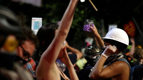 A demonstrator hands out earplugs to fellow protesters to block out the sounds from flashbangs used by security forces, at a protest against racial inequality and police violence in Portland, Oregon, U.S., July 26, 2020. A demonstrator hands out earplugs to fellow protesters to block out the sounds from flashbangs used by security forces, at a protest against racial inequality and police violence in Portland, Oregon, U.S., July 26, 2020. - Sputnik International