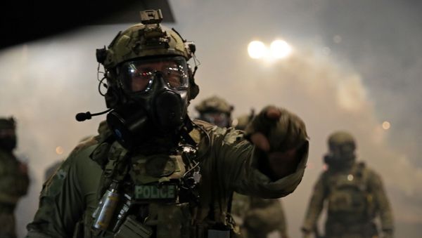 Federal law enforcement officers gather as demonstrators protest against racial inequality and police violence in Portland, Oregon, U.S., July 26, 2020. - Sputnik International