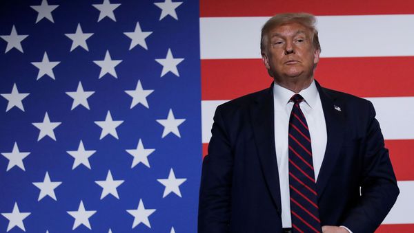 U.S. President Donald Trump stands in front of a U.S. flag as he participates in a roundtable on donating plasma during a visit to the American Red Cross National Headquarters in Washington, U.S., July 30, 2020 - Sputnik International