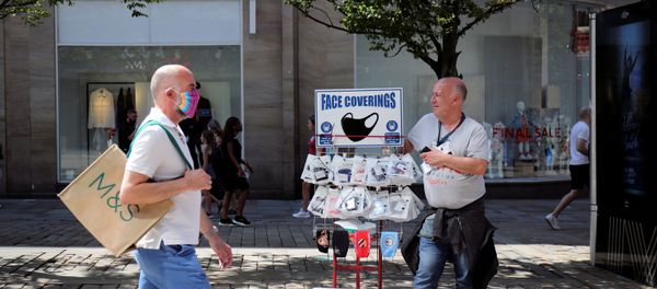 A man sells protective masks, as the city and surrounding area face local restrictions in an effort to avoid a local lockdown being forced upon the area, amid the coronavirus (COVID-19) outbreak, in Manchester A man sells protective masks, as the city and surrounding area face local restrictions in an effort to avoid a local lockdown being forced upon the area, amid the coronavirus (COVID-19) outbreak, in Manchester - Sputnik International