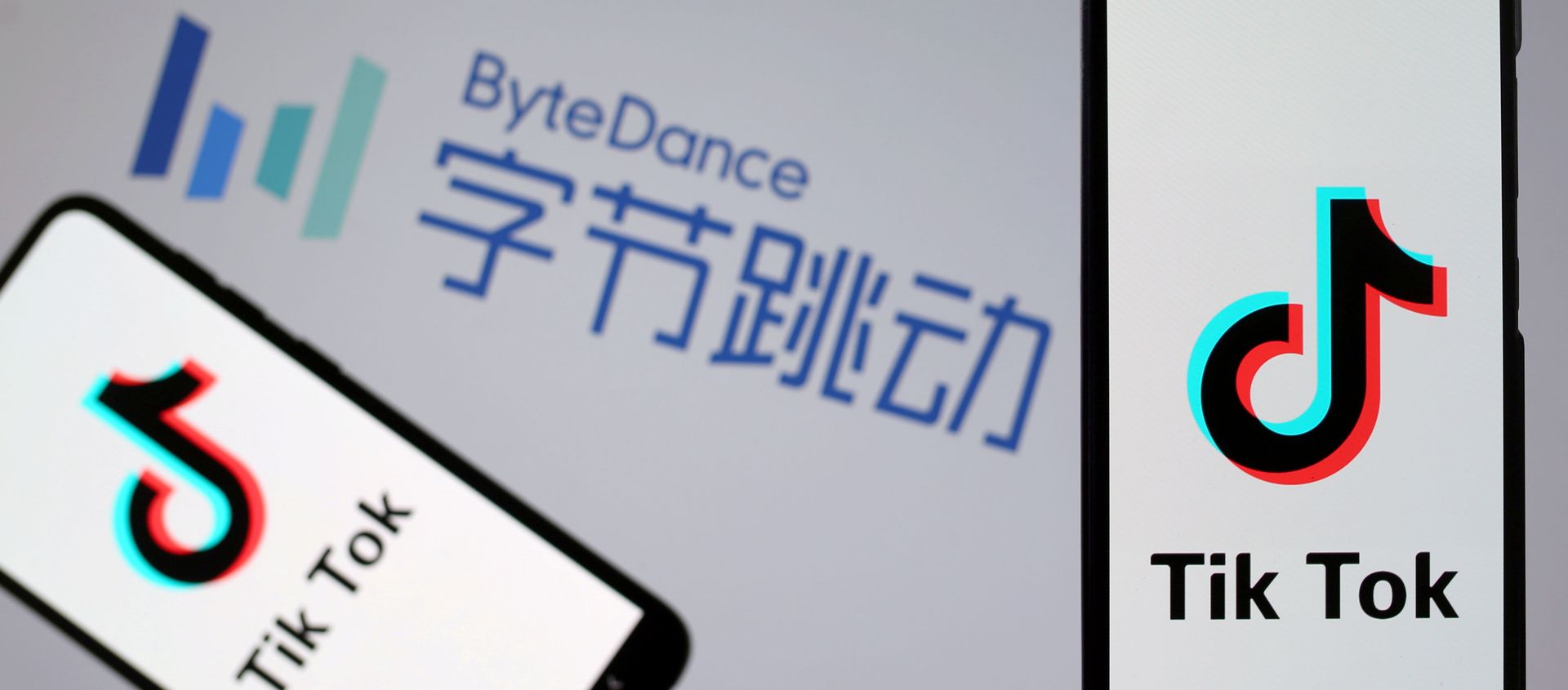 TikTok logos are seen on smartphones in front of a displayed ByteDance logo in this illustration taken November 27, 2019. - Sputnik International, 1920, 12.08.2020