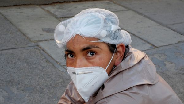 A woman wearing a protective suit waits for health information about her relative infected with coronavirus disease (COVID-19) at the Hospital de Clinicas, in La Paz, Bolivia, July 26, 2020. - Sputnik International
