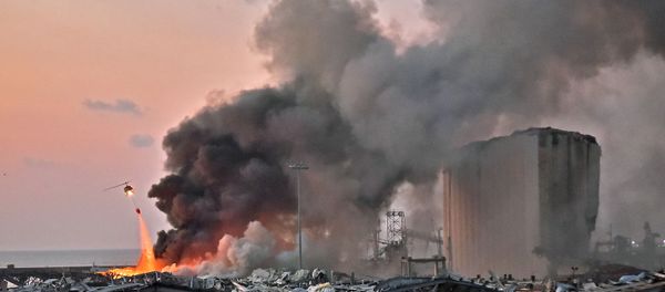 EDITORS NOTE: Graphic content / A helicopter puts out a fire at the scene of an explosion at the port of Lebanon's capital Beirut on August 4, 2020. (Photo by STR / AFP) - Sputnik International