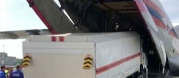 A Russian Emergencies Ministry's truck with humanitarian aid drives into a cargo plane heading to Beirut, a day after a massive explosion in the port of Lebanon's capital, in Moscow Region, Russia, in this still image from handout video taken August 5, 2020 - Sputnik International