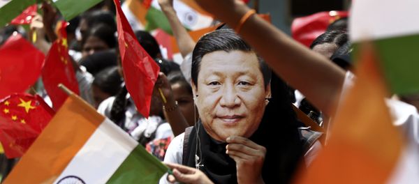 FILE- In this 10 October 2019 file photo, an Indian schoolgirl wears a face mask featuring Chinese President Xi Jinping to welcome him on the eve of his visit in Chennai, India FILE- In this 10 October 2019 file photo, an Indian schoolgirl wears a face mask featuring Chinese President Xi Jinping to welcome him on the eve of his visit in Chennai, India - Sputnik International