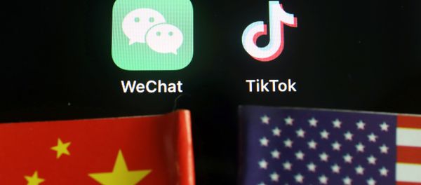 The messenger app WeChat and short-video app TikTok are seen near China and U.S. flags in this illustration picture taken August 7, 2020 - Sputnik International