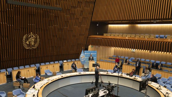 This handout photo provided by the World Health Organization (WHO) on May 18, 2020, shows a general view of the World Health Organization assembly room with WHO Director-General Tedros Adhanom Ghebreyesus delivering a speech in front of a blue backdrop at the opening of the World Health Assembly virtual meeting This handout photo provided by the World Health Organization (WHO) on May 18, 2020, shows a general view of the World Health Organization assembly room with WHO Director-General Tedros Adhanom Ghebreyesus delivering a speech in front of a blue backdrop at the opening of the World Health Assembly virtual meeting - Sputnik International