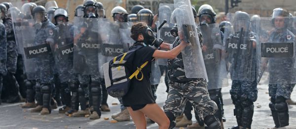 A Lebanese policeman hits a demonstrator during clashes in downtown Beirut on August 8, 2020, following a demonstration against a political leadership they blame for a monster explosion that killed more than 150 people and disfigured the capital Beirut. A Lebanese policeman hits a demonstrator during clashes in downtown Beirut on August 8, 2020, following a demonstration against a political leadership they blame for a monster explosion that killed more than 150 people and disfigured the capital Beirut. - Sputnik International