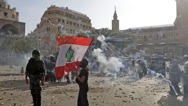 A Lebanese protester waves the national flag during clashes with security forces in downtown Beirut on August 8, 2020, following a demonstration against a political leadership they blame for a monster explosion that killed more than 150 people and disfigured the capital Beirut. A Lebanese protester waves the national flag during clashes with security forces in downtown Beirut on August 8, 2020, following a demonstration against a political leadership they blame for a monster explosion that killed more than 150 people and disfigured the capital Beirut. - Sputnik International