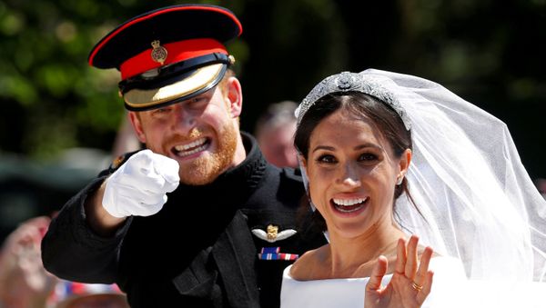 Britain’s Prince Harry gestures next to his wife, Meghan, as they ride a horse-drawn carriage after their wedding ceremony at St George’s Chapel in Windsor Castle in Windsor, Britain, May 19, 2018 - Sputnik International
