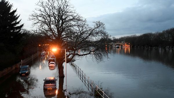 Cars are surrounded by water on a flooded road beside the River Thames in west London, Britain - Sputnik International