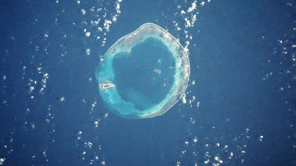 Satellite photo of Pratas (Dongsha) Island, a 590-acre island which sits 270 miles south of Taiwan and 200 miles east of China in the South China Sea. It is controlled by Taiwan. The island is on the left side - the rest is submerged reef. - Sputnik International