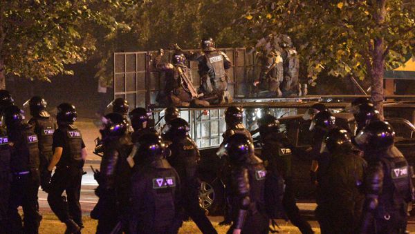 Riot police march during clashes with opposition supporters after polls closed in Belarus' presidential election, in Minsk, Belarus. - Sputnik International