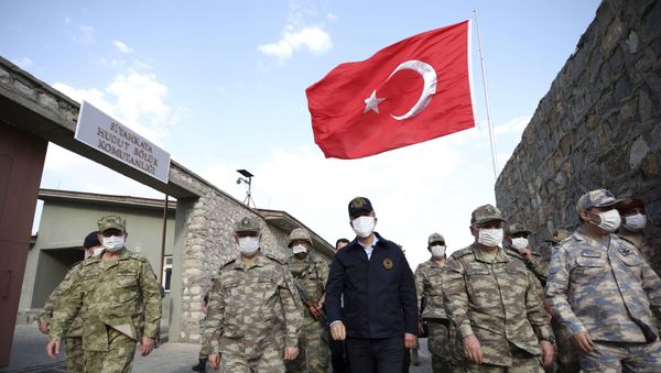 In this photo taken Friday, June 19, 2020, Turkish Defense Minister Hulusi Akar, centre, wearing a face mask to protect against coronavirus, visits Turkish troops at the border with Iraq, in Hakkari province, Turkey. Turkish army's operation continues after it said Wednesday it has airlifted troops for a cross-border ground operation against Kurdish militants in northern Iraq In this photo taken Friday, June 19, 2020, Turkish Defense Minister Hulusi Akar, centre, wearing a face mask to protect against coronavirus, visits Turkish troops at the border with Iraq, in Hakkari province, Turkey. Turkish army's operation continues after it said Wednesday it has airlifted troops for a cross-border ground operation against Kurdish militants in northern Iraq - Sputnik International