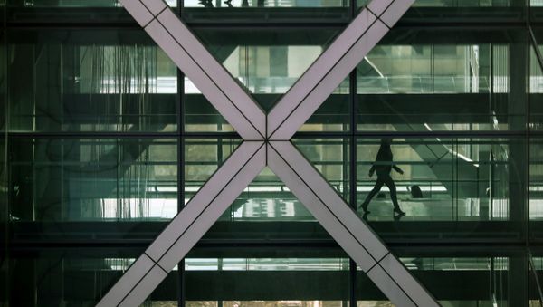 FILE PHOTO: People walk in an office in the financial centre of Canary Wharf in London, Britain March 6, 2020 - Sputnik International