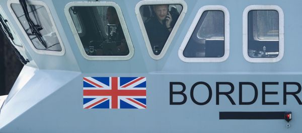 An officer looks out of a window at Dover harbour from a Border Force boat, in Dover, Britain August 11, 2020. An officer looks out of a window at Dover harbour from a Border Force boat, in Dover, Britain August 11, 2020. - Sputnik International