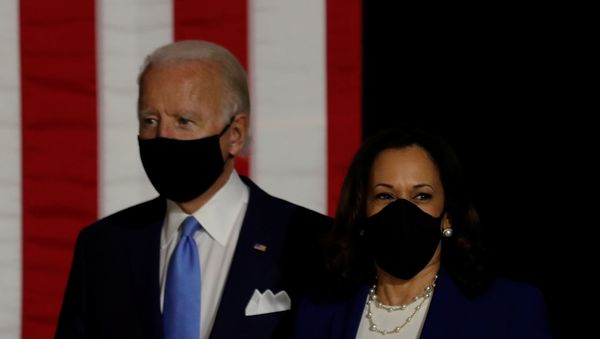 Democratic presidential candidate and former Vice President Joe Biden; and vice presidential candidate Senator Kamala Harris take the stage at a campaign event, their first joint appearance since Biden named Harris as his running mate, at Alexis Dupont High School in Wilmington, Delaware, U.S., August 12, 2020.  - Sputnik International