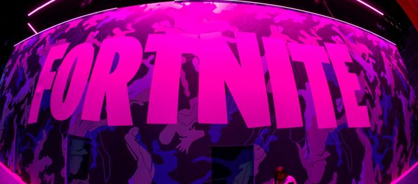 An attendee stops to text next to Epic Games Fortnite sign at E3, the annual video games expo revealing the latest in gaming software and hardware in Los Angeles, California, U.S., June 12, 2019. - Sputnik International