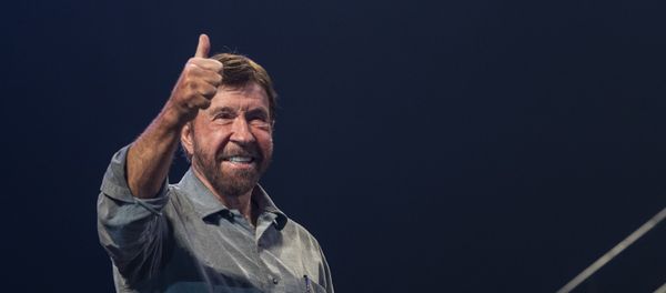 US actor and martial artist Chuck Norris, this year's special guest signals to the audience onstage during the opening gala of the 15th Shoe Box fundraising event in Papp Laszlo Sports Arena in Budapest, Hungary, Saturday, Nov. 24, 2018. The annual Christmas charity campaign was launched by the Hungarian Baptist Aid (HBAid) in 2004 to collect and distribute gifts donated by the public for underprivileged children during Advent. The organisation receives the labelled and boxed presents at nearly 300 designated collection points in the country.  - Sputnik International