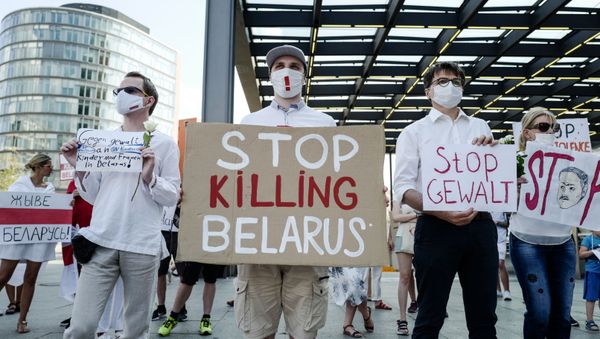 A protester holds a sign reading Stop Killing Belarus during a demonstration on the contested elections in Belarus in Berlin, on August 15, 2020. A protester holds a sign reading Stop Killing Belarus during a demonstration on the contested elections in Belarus in Berlin, on August 15, 2020. - Sputnik International
