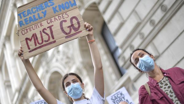 People take part in a protest in Westminster in London over the government's handling of A-level results, Friday, Aug. 14, 2020. Thousands of school-leaving children in Britain have been left distraught after finding out that they were handed lower-than-expected grades. The government is under growing pressure to address the question of how to fairly award students grades in the absence of actual exams. - Sputnik International