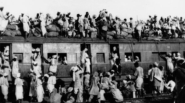 In this September 1947, file photo hundreds of Muslim refugees crowd on top a train leaving New Delhi for Pakistan. After Britain ended its colonial rule over the Indian subcontinent, two independent nations were created in its place _ the secular, Hindu-majority nation of India, and the Islamic republic of Pakistan. The division, widely referred to as Partition, sparked massive rioting that killed up to 1 million, while another 15 million fled their homes in one of the world’s largest ever human migrations. (AP Photo, File) - Sputnik International