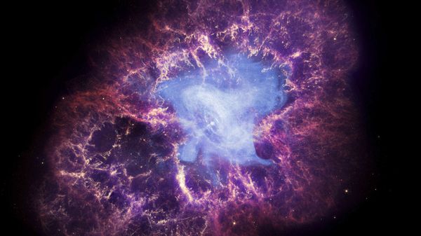 This composite image made available by NASA shows a neutron star, center, left behind by the explosion from the original star's death in the constellation Taurus, observed on Earth as the supernova of A.D. 1054. This image uses data from three of NASA's observatories: the Chandra X-ray image is shown in blue, the Hubble Space Telescope optical image is in red and yellow, and the Spitzer Space Telescope's infrared image is in purple. After nearly two decades in Earth orbit, scanning the universe with infrared eyes, ground controllers plan to put the faltering Spitzer Space Telescope into permanent hibernation on Thursday, Jan. 29, 2020 - Sputnik International